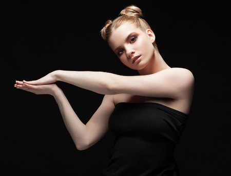 Young teen female beauty low key portrait with day makeup on black backgroundの写真素材