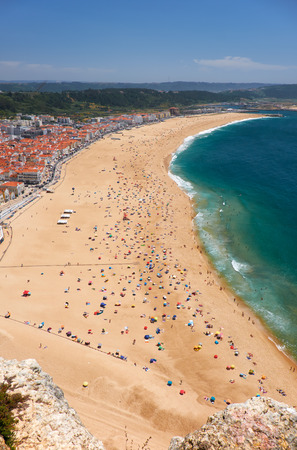 Bird's-eye view on Nazare beach riviera on the coast of Atlantic ocean with Nazare town. Portugalの写真素材