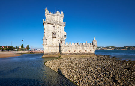 LISBON, PORTUGAL - JULY 3, 2016: Wide angle shot of Belem Tower (Tower of St Vincent) on river Tagus in Lisbon with reflection in water on blue sky background, Portugalのeditorial素材