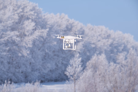 ALTAI, RUSSIA - JANUARY 18, 2017: Copter Phantom on forest under snow background in winter season. Altai, Siberia, Russiaのeditorial素材