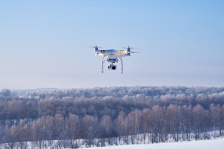 ALTAI, RUSSIA - JANUARY 18, 2017: Copter Phantom on forest under snow background in winter season. Altai, Siberia, Russiaのeditorial素材