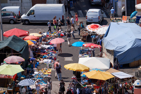 LISBON, PORTUGAL - JUNE 25, 2016:  The merchant laiding out his goods on the ground in the flea market in Alfama. Lisbon. Portugalのeditorial素材