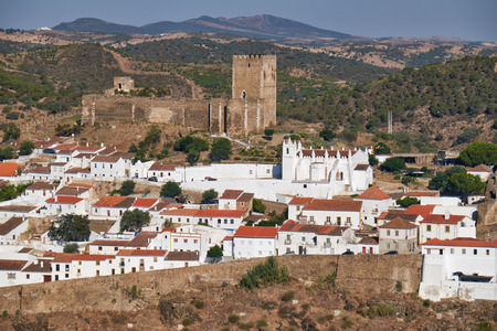 Mertola with the old mediaeval castle on the hill as viewed from the high opposite side of the Guadiana river. Portugalの写真素材