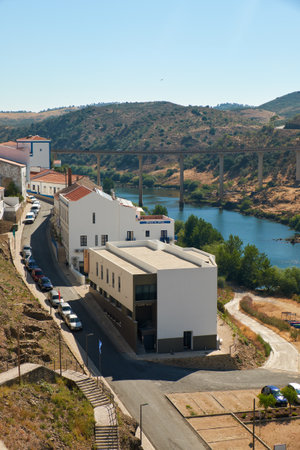 MERTOLA, PORTUGAL - JUNE 30, 2016:  View of Rua Dr. Afonso Costa in small town of Mertola with the Bridge over the Guadiana river on the background. Portugalのeditorial素材