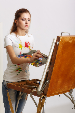 Painter woman with wooden sketchbook and paintingの写真素材