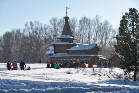NOVOSIBIRSK, RUSSIA - JANUARY 11, 2018: Troika of horses harnessed to a sleigh.  Slavonic folk winter festivities Shrovetide. Church of the Savior. Historical and Architectural Museum in the open airのeditorial素材