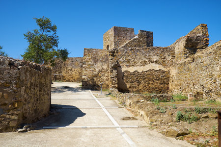MERTOLA, PORTUGAL - JUNE 30, 2016:  The view of inner courtyard with the Carouche Tower of the...