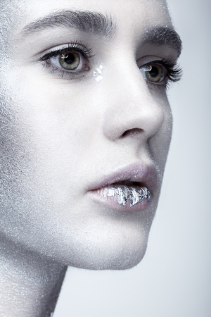 Closeup macro beauty portrait of young woman face. の写真素材