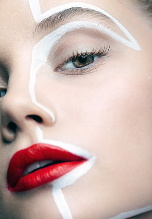 Close-up beauty fashion shot of female face. Portrait of a young woman. Girl with an unusual creative makeup.の写真素材