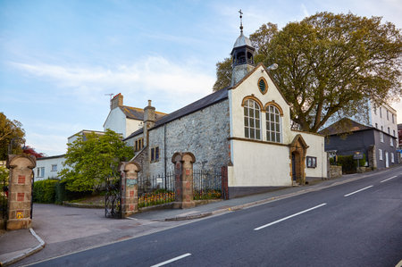 LYME REGIS, ENGLAND - MAY 12, 2009: The small church (now the Alexandra hotel) with bell tower beside the entrance to Langmoor Gardens, Lyme Regis. Englandのeditorial素材