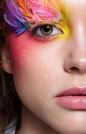Close-up  shot of female face. Woman with bright stylish eyes make-up and false fashion feather eyelashesの写真素材