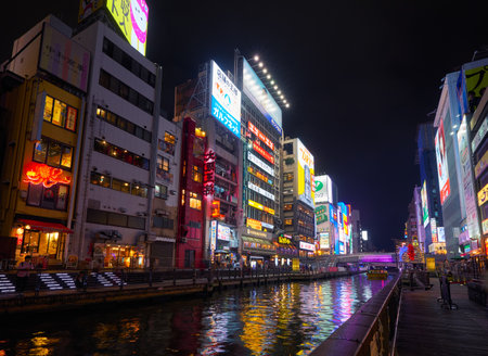OSAKA, JAPAN - OCTOBER 14, 2019:  The bright night illumination over the Dotonbori canal in the Namba district of the city's Chuo ward. Osaka. Japanのeditorial素材