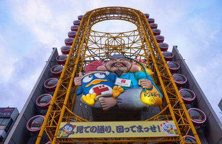 OSAKA, JAPAN - OCTOBER 14, 2019:  The bottom up view on the huge, oblong, yellow Ferris wheel of Don...