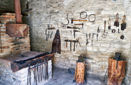 LEFKARA, CYPRUS - JUNE 14, 2018: The exhibition of blacksmith craft work examples on the wall in Local Ethnological Museum. Pano Lefkara village. Cyprusのeditorial素材