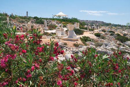 AYIA NAPA, CYPRUS - JUNE 18, 2018: The view of  Ayia Napa international Sculpture Park - the open air sculpture museum on the slope of mountain with the oleander on the foreground. Cyprusのeditorial素材