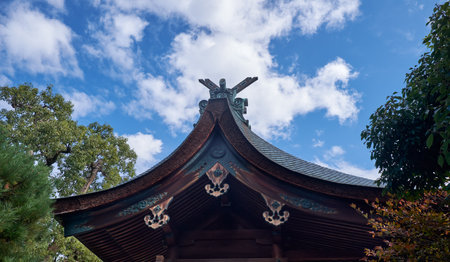 Cypress bark roof of Shikichi-jinja shrine main hall (honden) decorated with chigi (forked roof...