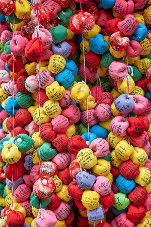 KYOTO, JAPAN - OCTOBER 18, 2019:  Kukurizaru, the ball-shaped talisman, made of colorful cloth with the wishes of worshippers, representing the good faith monkeys at Yasaka Koshin-do temple.のeditorial素材
