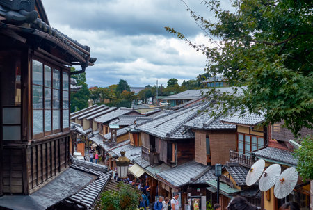 KYOTO, JAPAN - OCTOBER 18, 2019:  The tiled roofs of  traditional wooden townhouses (machiya) along shopping Sannenzaka street near Kiyomizu-dera temple. Higashiyama. Kyoto. Japanのeditorial素材