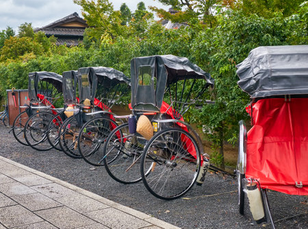 KYOTO, JAPAN - OCTOBER 18, 2019: A pulled rickshaw carts (or ricksha) parked on the street of old...