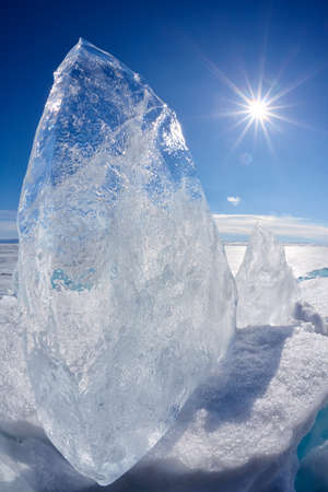 Ice floe and sun over winter Baikal lake
