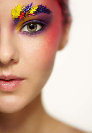 Close-up female portrait with half face and with shallow depth of focus. Unusual art make-up with...
