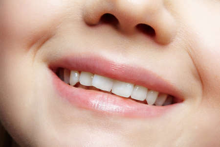 Human mouth and nose. Closeup macro portrait of young female teenager part of face.