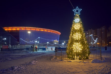 Yekaterinburg, Russia - January 03, 2021: The New Year tree brightly decorated for the holiday in front of illuminated Ekaterinburg Arena. Yekaterinburg. Russiaのeditorial素材