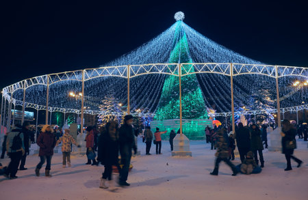Nizhny Tagil, Russia - January 05, 2021: Public festivals under the brightly illuminated New Year tree on the Theater square. Nizhny Tagil. Russiaのeditorial素材