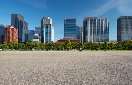 Skyscrapers of Marunouchi commercial and financial district, viewed through the paved paths of Tokyo Kokyo Gaien National Garden. Tokyo. Japanのeditorial素材