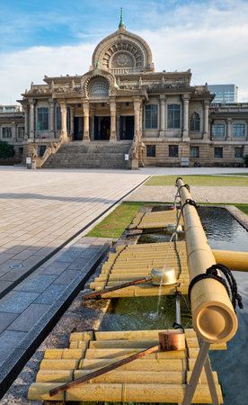The water ablution pavilion for ceremonial purification (Chozuya or temizuya) in front of Tsukiji Hongan-ji Buddhist temple. Tokyo, Japanのeditorial素材