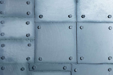 Background of silvery wall made of polyethylene foam sheets imitating metal with rivets. Iron wall background.の写真素材