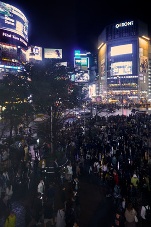 Tokyo, Japan - October 25, 2019: The night view of one of the busiest crossing in the world, Shibuya Crossing or Shibuya Scramble Crossing in front of the Shibuya Station. Tokyo. Japanのeditorial素材