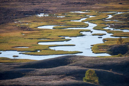 Altai river Kurkurek on Eshtykel plateau. Autumn, trees are in fall yellow colors. Altai, Siberia, Russiaの写真素材