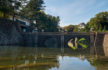 Seimon Ishibashi Bridge leads to the main gate of Imperial Palace. It is known as the Eyeglasses Bridge (Meganebashi) because of its stone-arch reflecting in the water of Nijubashi-moat. Tokyo. Japanのeditorial素材
