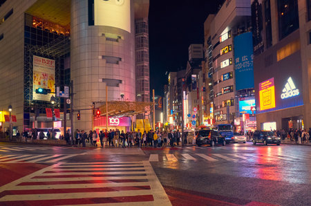 Tokyo, Japan - October 25, 2019: The night view of one of crossing of Shibuya shopping district surrounded by bright advertisements and banners. Tokyo. Japanのeditorial素材