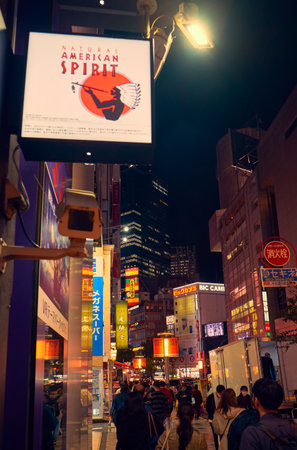 Tokyo, Japan - October 25, 2019: The busy nightlife in the street of Shibuya shopping district surrounded by bright advertisements and banners. Tokyo. Japanのeditorial素材