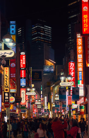 Tokyo, Japan - October 25, 2019: The busy nightlife in the street of Shibuya shopping district surrounded by bright advertisements and banners. Tokyo. Japanのeditorial素材