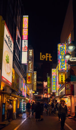 Tokyo, Japan - October 25, 2019: The busy nightlife in the street of Shibuya shopping district surrounded by bright advertisements and banners. Tokyo. Japanのeditorial素材
