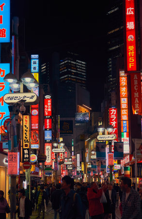 Tokyo, Japan - October 25, 2019: The busy nightlife in the street of Shibuya shopping district surrounded by bright advertisements and banners. Tokyo. Japanのeditorial素材