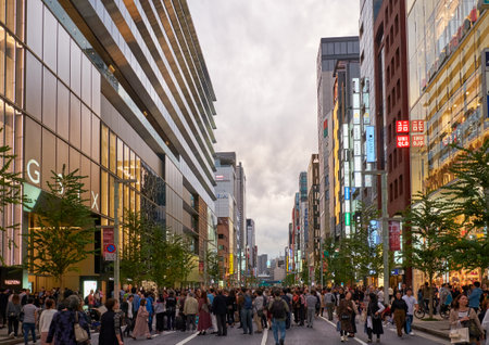 Tokyo, Japan - October 26, 2019: The evening view of busy street of Ginza shopping area, surrounded by the many shops, department stores, boutiques and restaurants icons. Chuo. Tokyo. Japanのeditorial素材