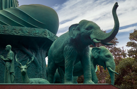 The figures of elephants, reindeer and monks surrounding Great Buddha statue at Toganji temple. Nagoya. Japanの写真素材