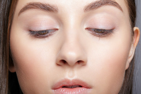 Close up shot of human female face. Woman with nude makeup of eyes or no visible makeup.の写真素材