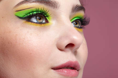 Close up shot of human female face. Woman with natural face and eyes beauty green makeup.