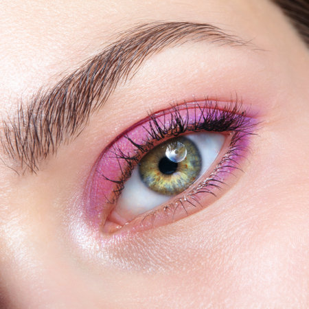 Closeup macro shot of human female eye. Woman with natural evening vogue face beauty makeup. Girl with perfect skin and pink smoky eyes eye shadows.の写真素材