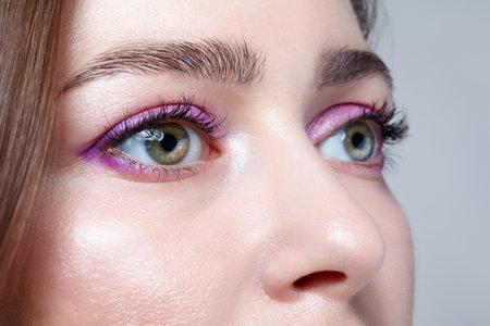 Close up shot of human female face. Woman with natural face and eyes beauty pink makeup.の素材 [FY310191389058]