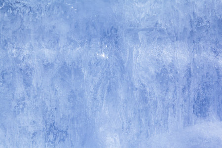 Texture of winter ice on a stone cliff. Blue natural ice background.の写真素材