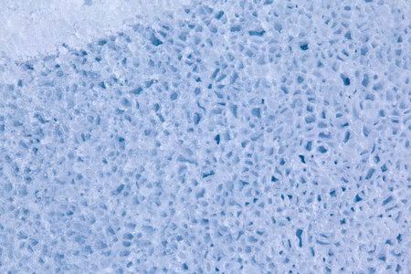 Texture of winter ice surface in the form of polygonal patterns. Blue natural ice background.の写真素材