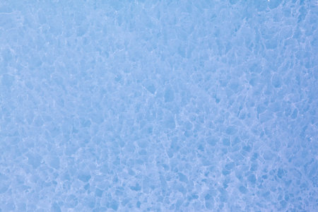 Texture of winter ice surface in the form of polygonal patterns. Blue natural ice background.の写真素材