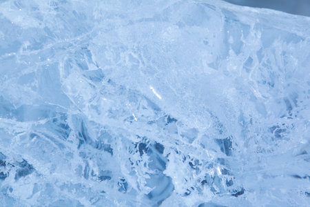 Texture of winter ice surface. Blue natural ice background.