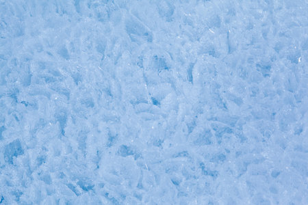 Texture of winter ice surface in the form of polygonal patterns. Blue natural ice background.の写真素材